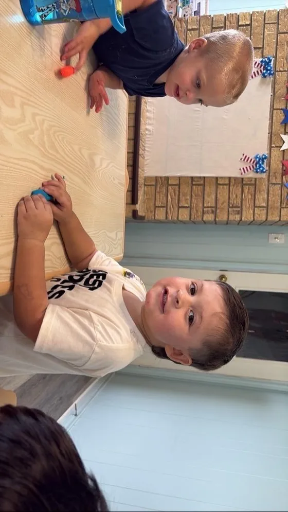 A child painting at an easel at Bright Haven